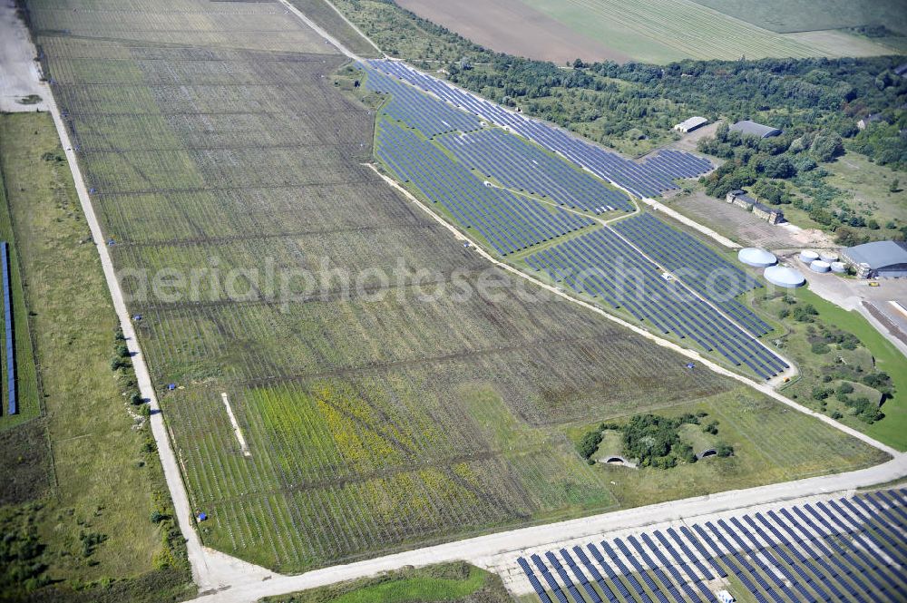 Köthen from the bird's eye view: Blick auf den Solarpark auf dem Flugplatz Köthen. Auf einer Fläche von 55 Hektar ist es das bundesweit zweitgrößte Photovoltaik-Kraftwerk und wurde 2008 in Betrieb genommen. Die hochmoderne PV-Anlage besteht aus ca. 200.000 dünnschicht Solarmodulen der Firma First Solar. Betrieben wird das Feld von der juwi solar GmbH. Solar Park at the former airfield Köthen.