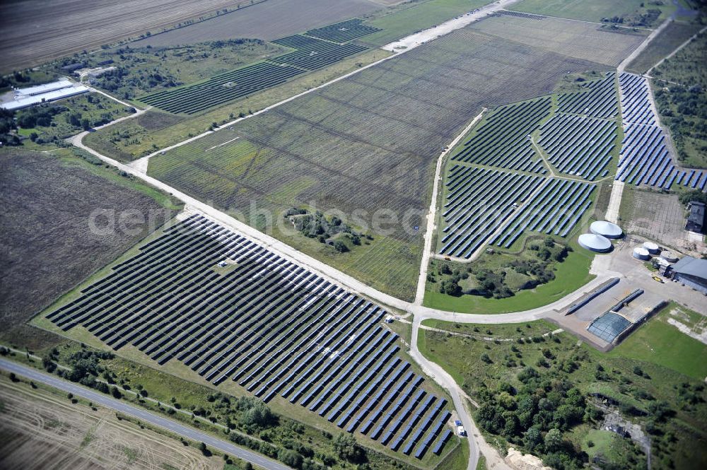 Köthen from above - Blick auf den Solarpark auf dem Flugplatz Köthen. Auf einer Fläche von 55 Hektar ist es das bundesweit zweitgrößte Photovoltaik-Kraftwerk und wurde 2008 in Betrieb genommen. Die hochmoderne PV-Anlage besteht aus ca. 200.000 dünnschicht Solarmodulen der Firma First Solar. Betrieben wird das Feld von der juwi solar GmbH. Solar Park at the former airfield Köthen.