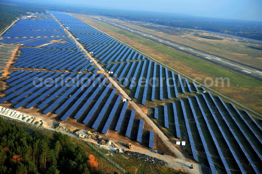 Aerial photograph Drewitz - Die fast abgeschlossenen Bauarbeiten für den Solarpark / die Photovoltaikanlage auf dem Flughafen Drewitz. Das Solarstrom-Kraftwerk Cottbus-Drewitz wurde durch die solarhybrid AG hat als Generalunternehmer und Projektentwickler auf dem ehemaligen Militärflughafen der NVA der DDR errichtet. Solar power station in Cottbus-Drewitz Airport.