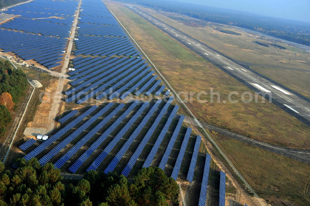 Aerial photograph Drewitz - Die fast abgeschlossenen Bauarbeiten für den Solarpark / die Photovoltaikanlage auf dem Flughafen Drewitz. Das Solarstrom-Kraftwerk Cottbus-Drewitz wurde durch die solarhybrid AG hat als Generalunternehmer und Projektentwickler auf dem ehemaligen Militärflughafen der NVA der DDR errichtet. Solar power station in Cottbus-Drewitz Airport.