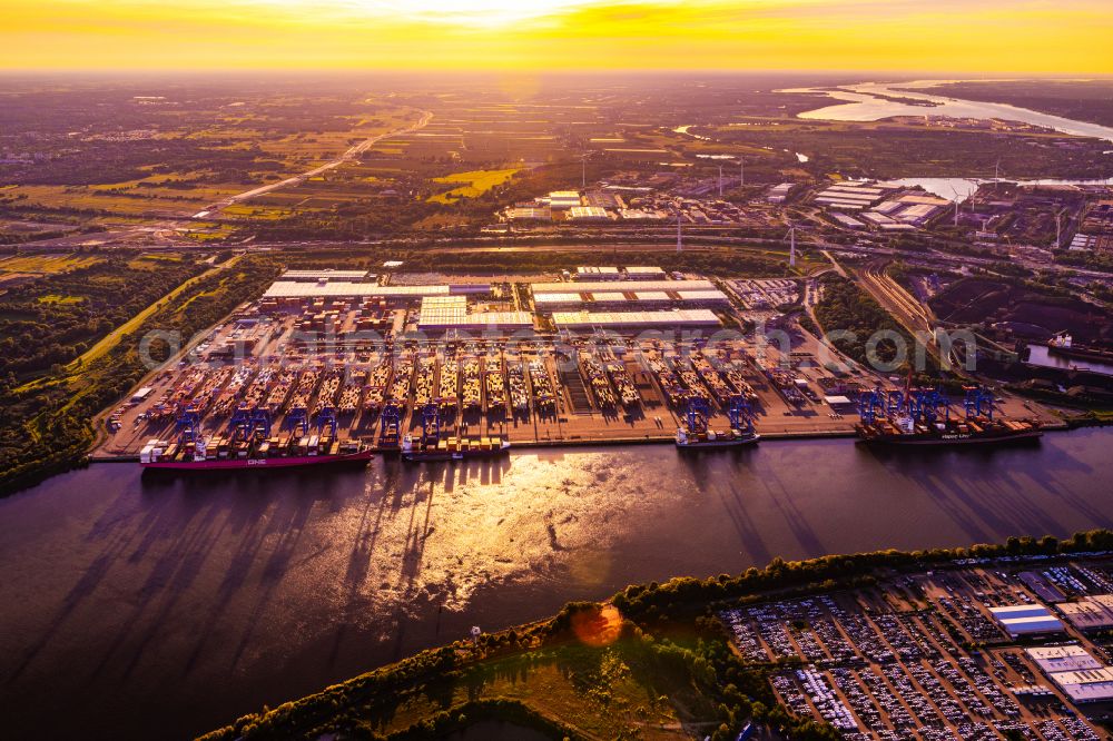 Aerial image Hamburg - Sunset over the landscape of harbor facilities along in Altenwerder district in Hamburg, Germany