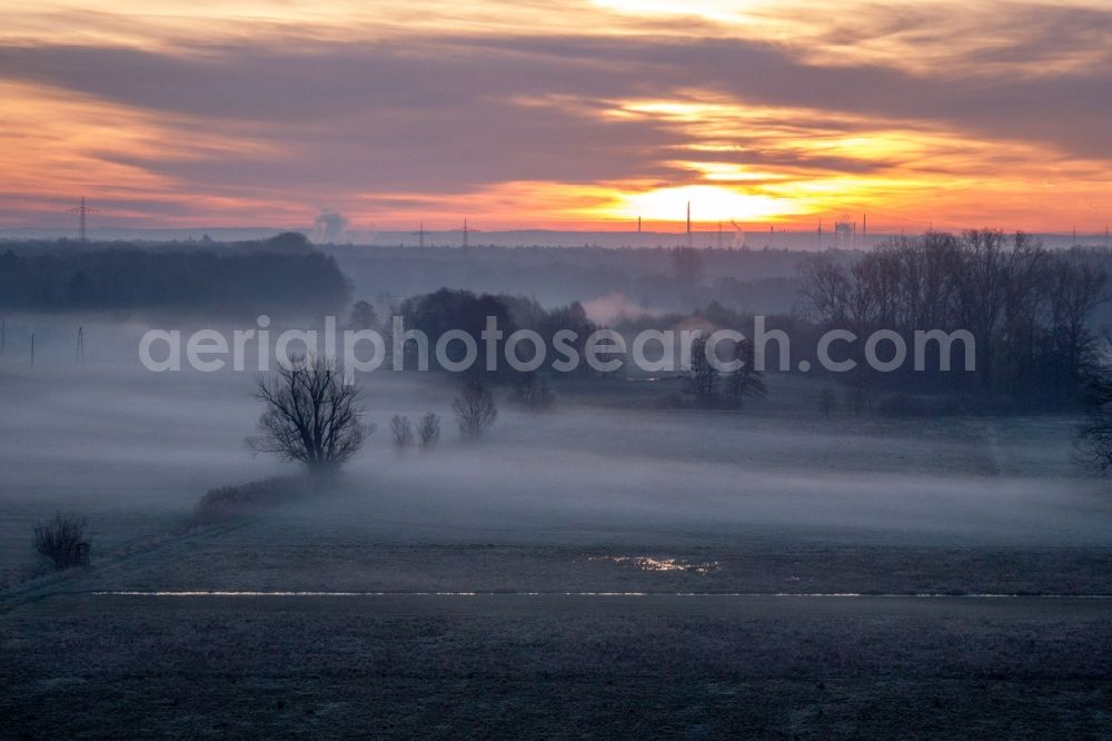 Aerial image Wörth am Rhein - Colorful sunrise over the countryside in Woerth am Rhein in the state Rhineland-Palatinate dyes the sky orange and yellow