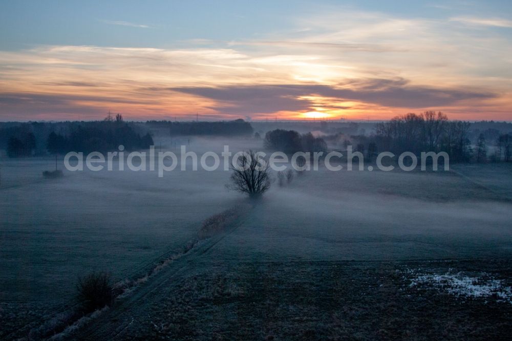 Aerial photograph Wörth am Rhein - Colorful sunrise over the countryside in Woerth am Rhein in the state Rhineland-Palatinate dyes the sky orange and yellow