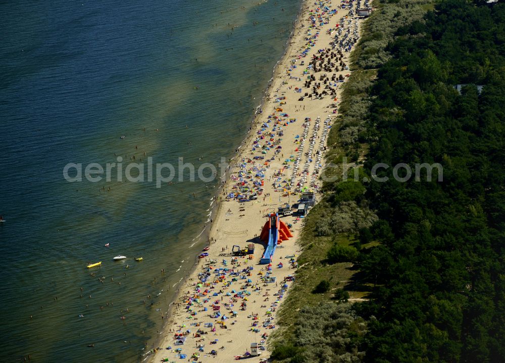 Aerial image Zinnowitz - Parasol - rows on the sandy beach in the coastal area of the Baltic Sea with a water slide in Zinnowitz on the island of Usedom in the state Mecklenburg - Western Pomerania, Germany