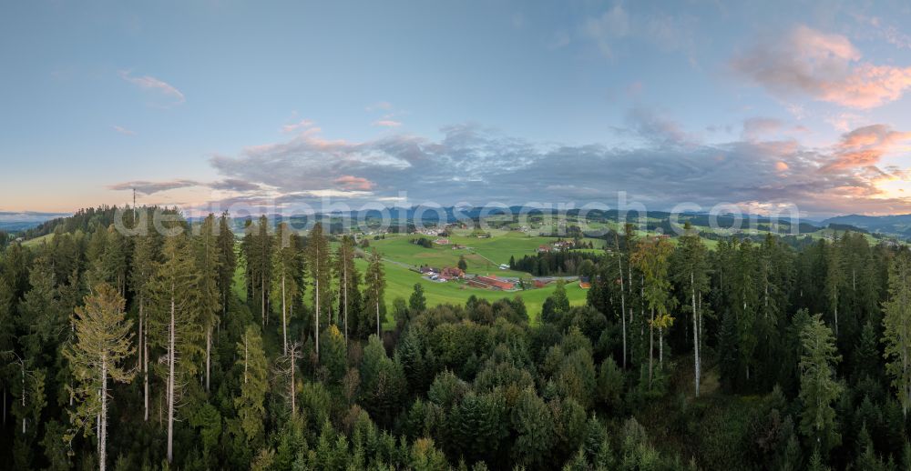 Langenried from above - Weather-related cloud layer over forest and meadow landscape at sunset in Langenried im Allgaeu in the federal state of Bavaria, Germany