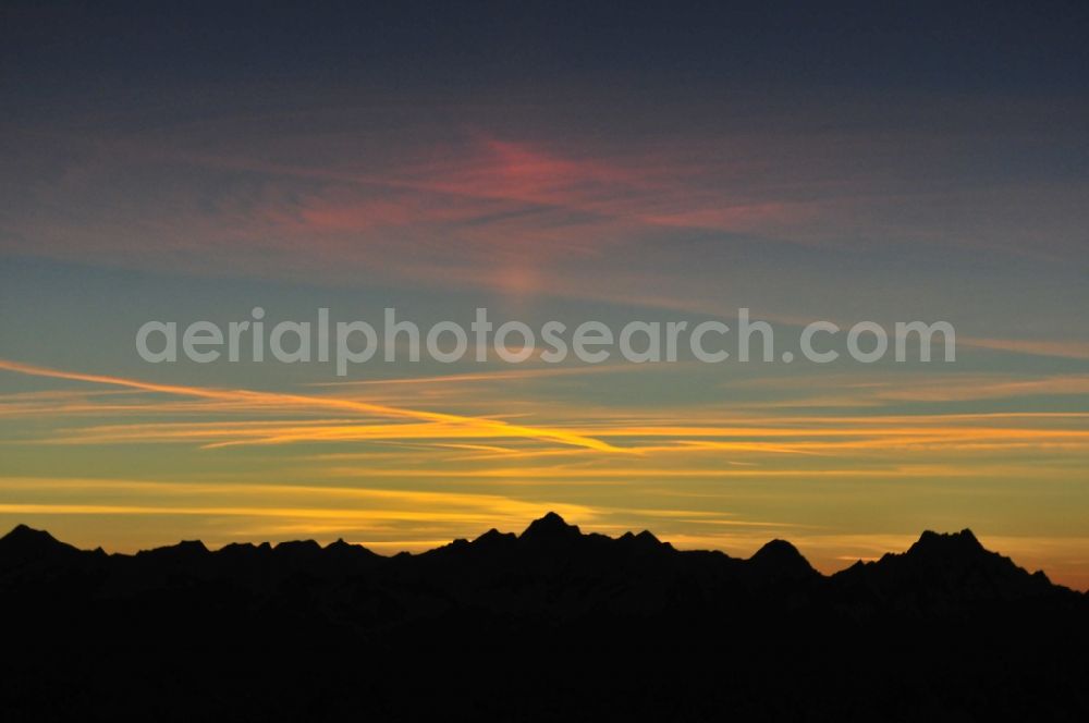 Wallis from the bird's eye view: Sunset with silhouette of mountain - summit of Mont Blanc, the highest mountain in the mountains of the Alps in the triangle in Valais in Switzerland