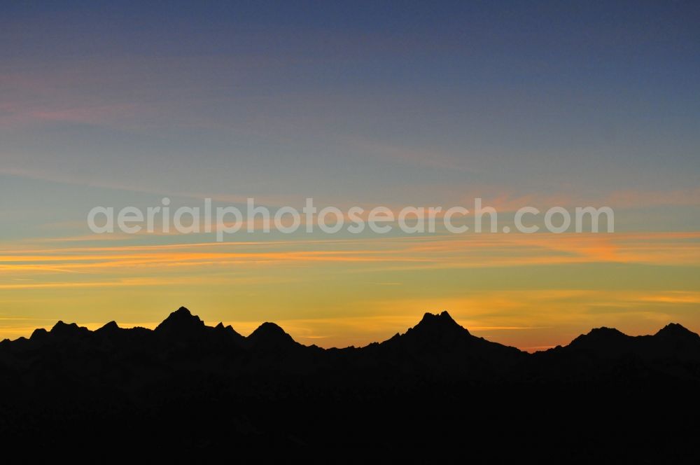 Aerial image Wallis - Sunset with silhouette of mountain - summit of Mont Blanc, the highest mountain in the mountains of the Alps in the triangle in Valais in Switzerland