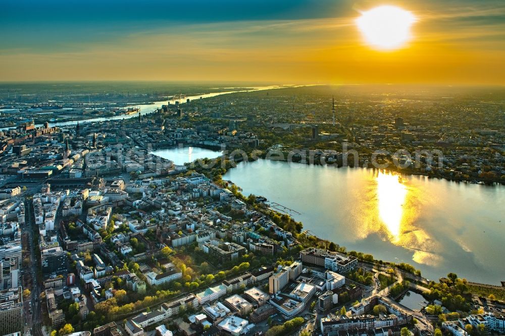 Hamburg from above - Golden yellow colored horizon at sunset over the bank areas at the lake area of the aussenalster in the city center in Hamburg