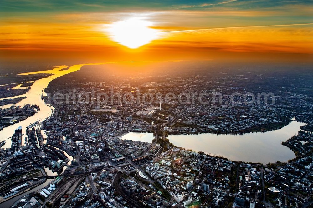 Hamburg from above - Golden yellow colored horizon at sunset over the bank areas at the lake area of the aussenalster in the city center in Hamburg