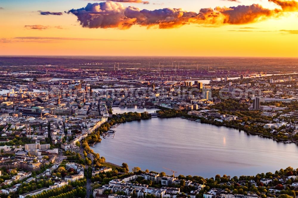 Hamburg from the bird's eye view: Golden yellow colored horizon at sunset over the bank areas at the lake area of the aussenalster in the city center in Hamburg