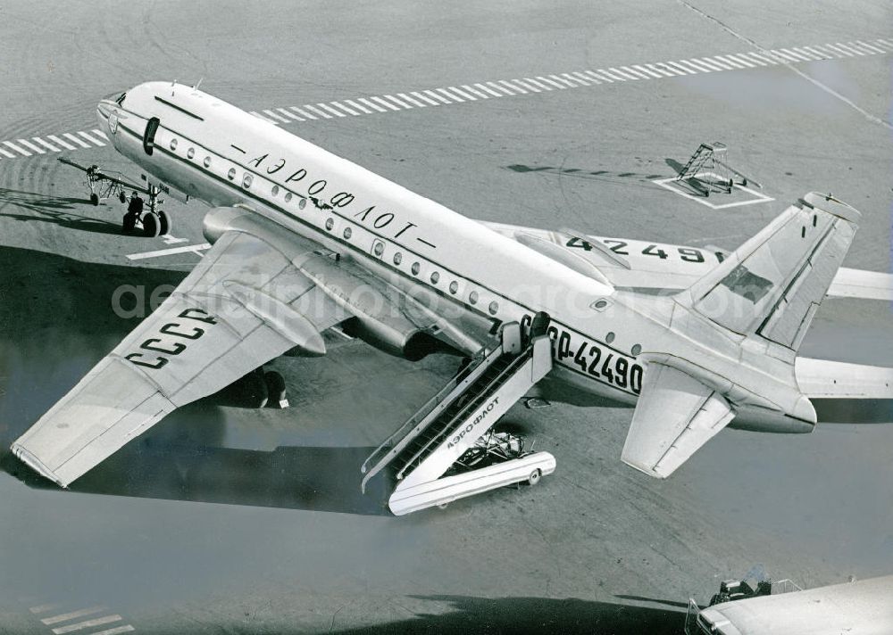 Aerial photograph Moskau - Sowjetisches Passagierflugzeug Tupolew Tu- 104 auf dem Moskauer Flughafen Scheremetjewo in Russland. Die Konstruktion des Tu- 104 entstammt den Tu 16- Bomber. Es ist das zweite Düsenverkehrsflugzeug der Welt. Den ersten Flug hatte die Tu-104 1955, ein Jahr später wurde die Maschine für den Linienverkehr genutzt. Die Produktion wurde 1960 eingestellt. Soviet Tupolev Tu-104 passenger plane at Moscow's Sheremetyevo airport in Russia. The design of the Tu-104 comes from the Tu 16 - Bomber.The first flight was 1955, one year later, the machine was used for regular services. Production was stopped 1960th.