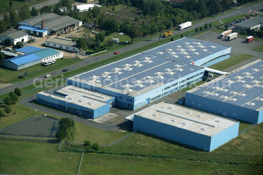 Jessen (Elster) from above - Freight forwarding building of the logistics and transport company Froehlich Trans in the commercial park of Jessen (Elster) in the state of Saxony-Anhalt. The two blue halls are locate adjacent to federal highway 187