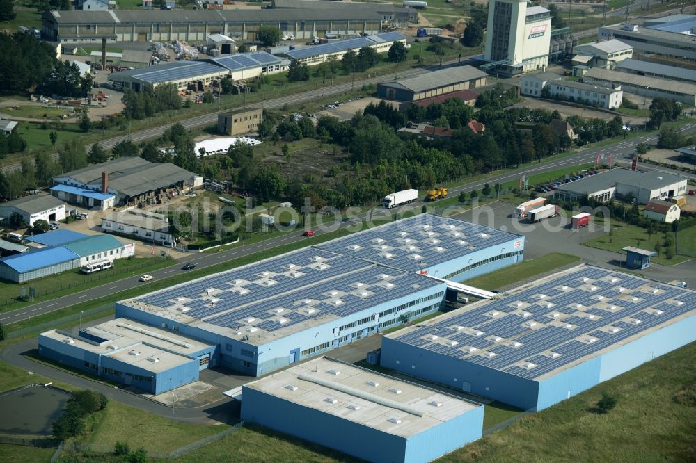 Jessen (Elster) from the bird's eye view: Freight forwarding building of the logistics and transport company Froehlich Trans in the commercial park of Jessen (Elster) in the state of Saxony-Anhalt. The two blue halls are locate adjacent to federal highway 187