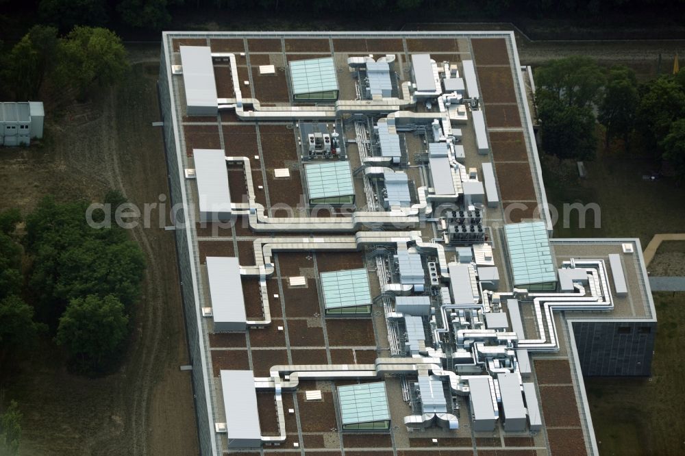 Berlin from above - Storage facilities on Fuerstenwalder Damm in the district of Treptow-Koepenick in Berlin in Germany. The magazine with its distinct architecture, facade and technical facilities on the roof was designed by architect Eberhard Wimmer. It is home to archives, depots and inventories of the State Library Berlin, the Ibero-American Institute and the image agency bpk