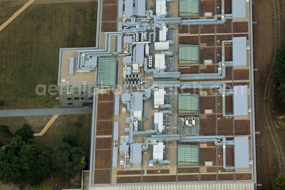 Aerial photograph Berlin - Storage facilities on Fuerstenwalder Damm in the district of Treptow-Koepenick in Berlin in Germany. The magazine with its distinct architecture, facade and technical facilities on the roof was designed by architect Eberhard Wimmer. It is home to archives, depots and inventories of the State Library Berlin, the Ibero-American Institute and the image agency bpk