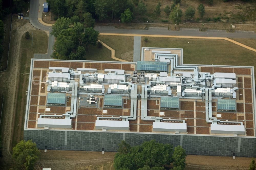 Aerial image Berlin - Storage facilities on Fuerstenwalder Damm in the district of Treptow-Koepenick in Berlin in Germany. The magazine with its distinct architecture, facade and technical facilities on the roof was designed by architect Eberhard Wimmer. It is home to archives, depots and inventories of the State Library Berlin, the Ibero-American Institute and the image agency bpk