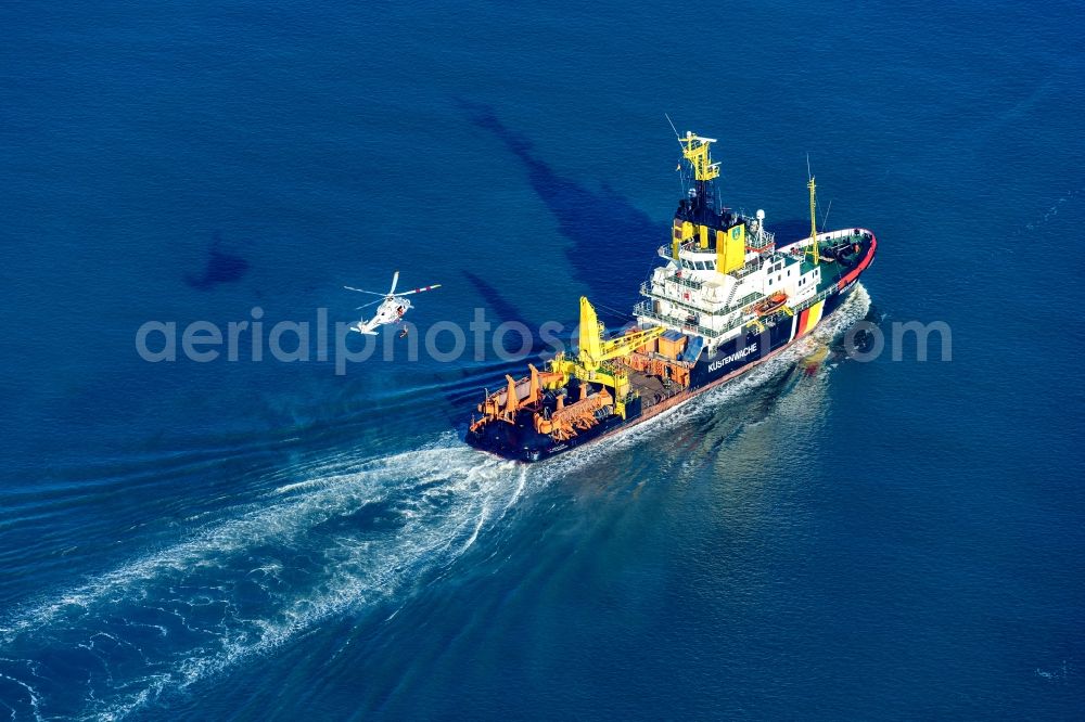 Wilhelmshaven from the bird's eye view: Special ship of the coast guard Mellum underway during a training mission with a helicopter IMO 8301981 in Wilhelmshaven on the Weser in front of the Jade Weserport in the state Lower Saxony, Germany