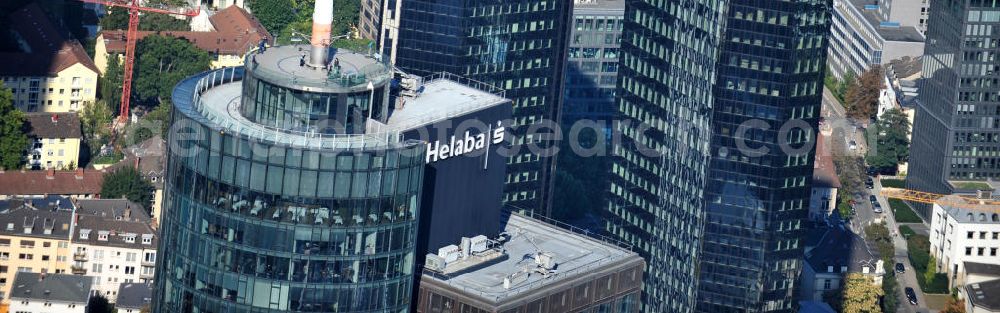 Aerial photograph Frankfurt am Main - Blick auf die Spitze des Main Tower , dem Hochhaus der HELABA Landesbank Hessen-Thüringen Girozentrale. Im Hintergrund die Hochhaus- Türme der Deutschen Bank. Zum Konzern Hessische Landesbank gehören die Frankfurter Sparkasse, die Tochtergesellschaften, Helaba Invest Kapitalanlagegesellschaft, die Frankfurter Bankgesellschaft und die OFB-Gruppe, die in der Immobilienprojektentwicklung tätig ist. Seit seiner Fertigstellung im Jahr 2000 gehört die Aussichtsplattform des MAIN TOWER zu den meistbesuchten Sehenswürdigkeiten in Frankfurt. View the top of the Main Tower, the skyscraper ofHELABA in Frankfurt.