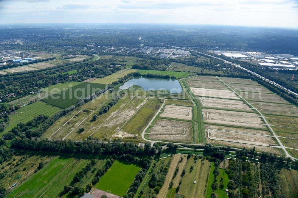 Hamburg from above - Grass surface structures of a meadow and field landscape as rinsing fields on the Moorburger Elbdeich on the A7 motorway in the Moorburg district of Hamburg, Germany