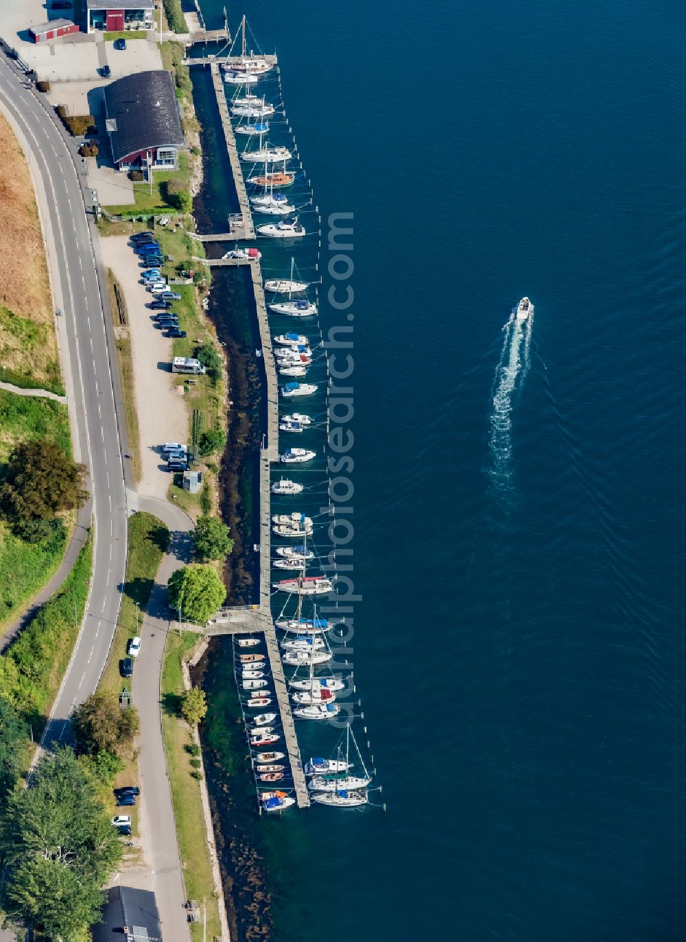 Sonderborg from above - Pleasure boat marina with docks and moorings on the shore area of Meerenge Alssund in Sonderborg in Syddanmark, Denmark