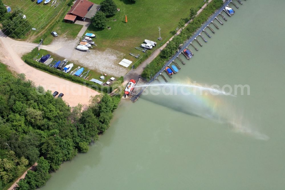 Wehr from the bird's eye view: Pleasure boat marina with docks and moorings on the shore area of the river Rhine in Wehr in the state Baden-Wuerttemberg. Water jet from a fire engine