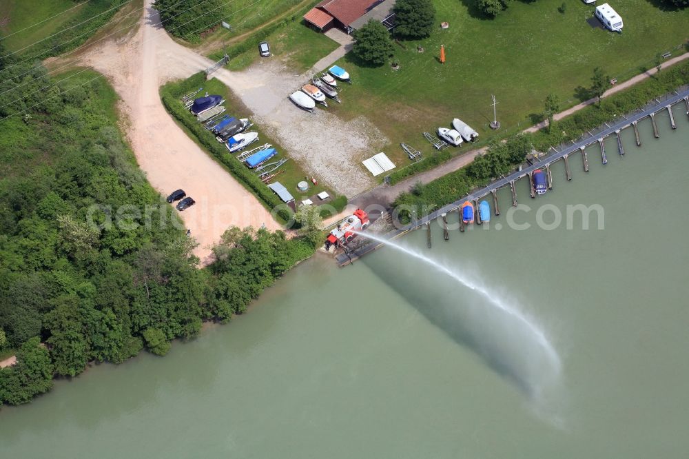 Aerial image Wehr - Pleasure boat marina with docks and moorings on the shore area of the river Rhine in Wehr in the state Baden-Wuerttemberg. Water jet from a fire engine