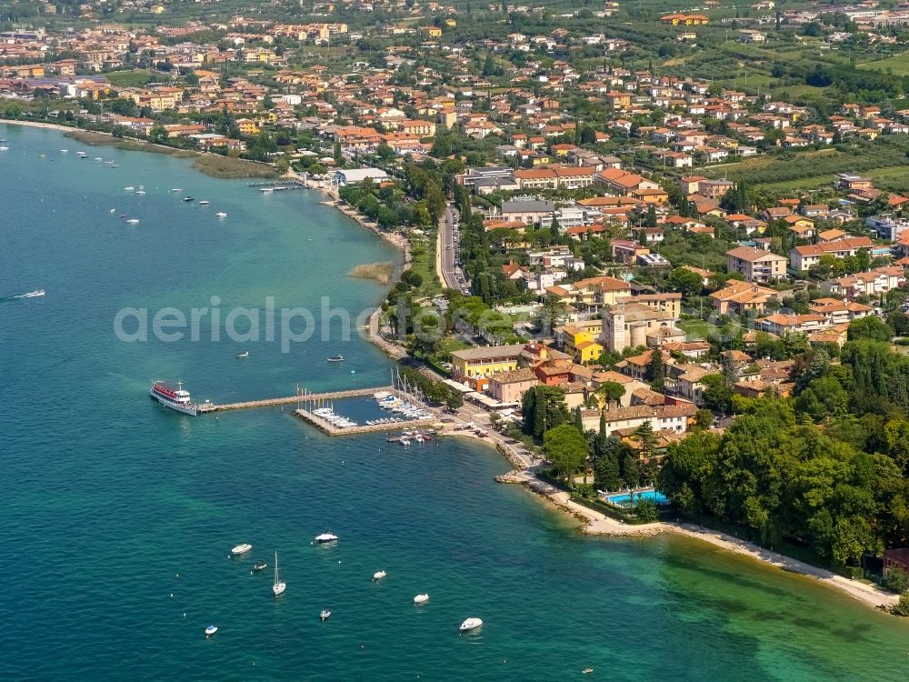 Aerial image Bardolino - Pleasure boat marina with docks and moorings on the shore area in Bardolino in Veneto, Italy