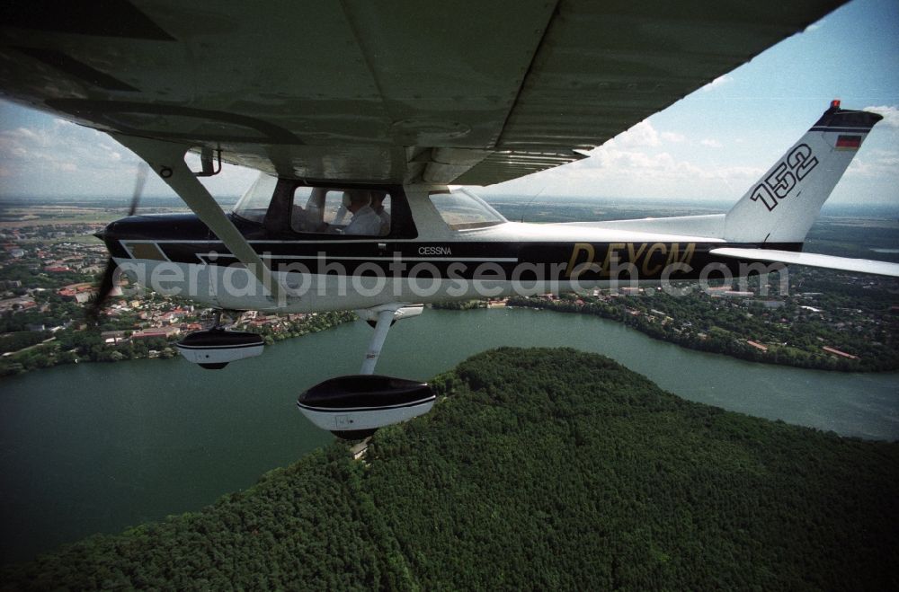 Strausberg from above - Sport airplane Cessna 152 flight school AERO TOURS - PEGASUS after starting on the airfield Strausberg in Brandenburg