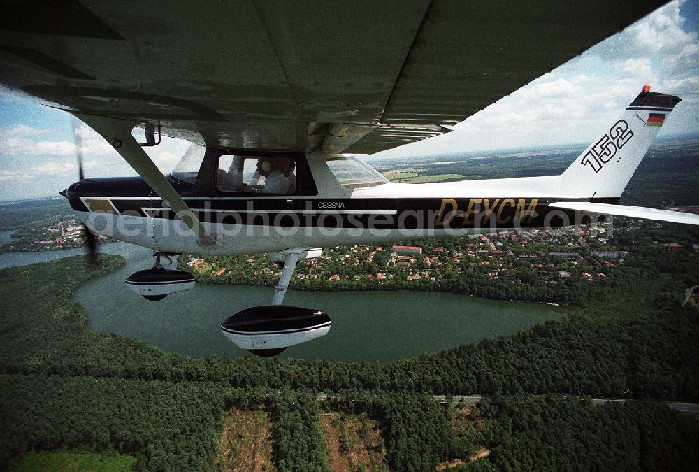 Aerial photograph Strausberg - Sport airplane Cessna 152 flight school AERO TOURS - PEGASUS after starting on the airfield Strausberg in Brandenburg