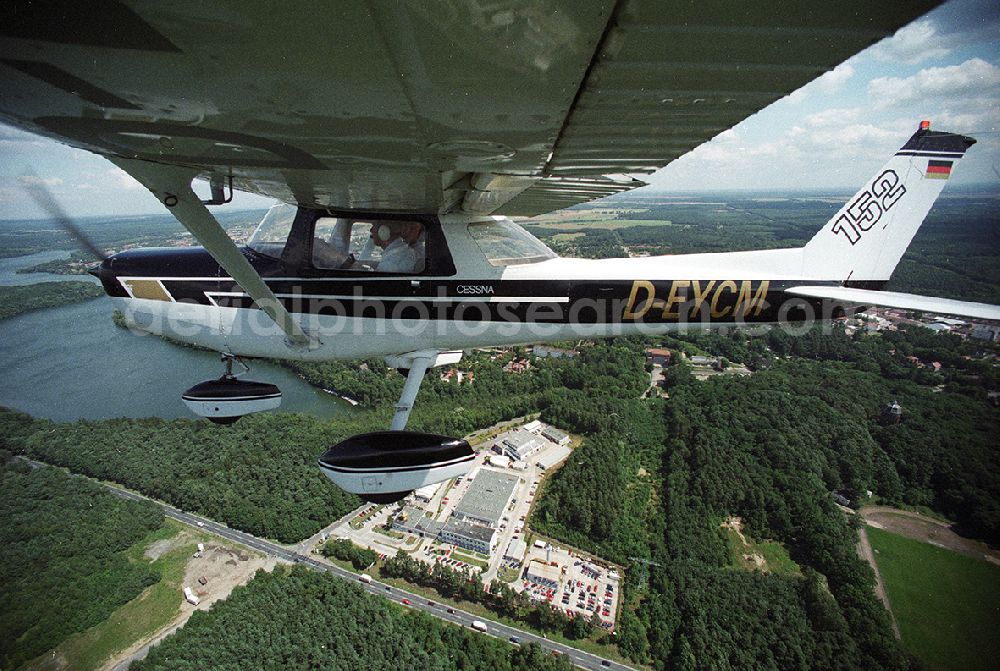 Strausberg from above - Sport airplane Cessna 152 flight school AERO TOURS - PEGASUS after starting on the airfield Strausberg in Brandenburg