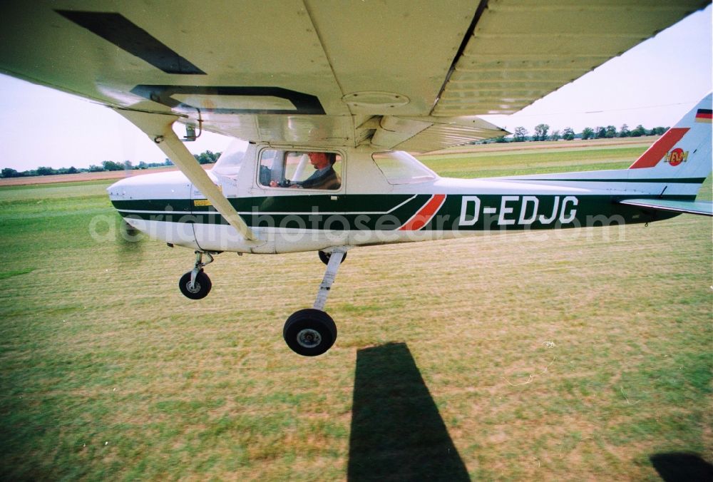 Bienenfarm Paulinenaue from above - Sport airplane Cessna 150 after starting at the airfield Bienenfarm - Paulinenaue in Brandenburg