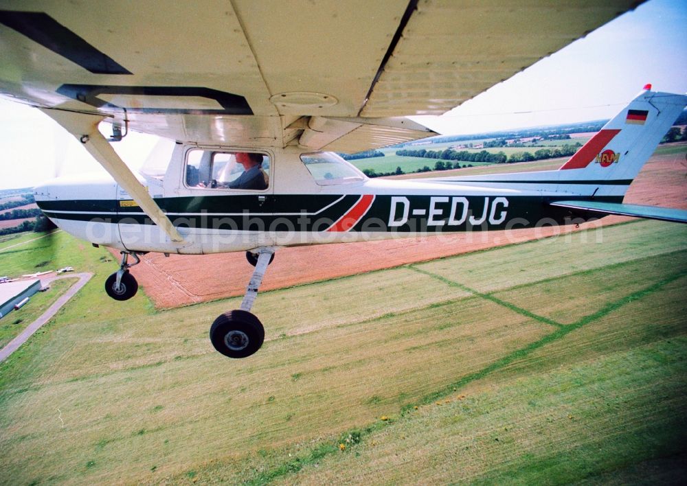 Aerial image Bienenfarm Paulinenaue - Sport airplane Cessna 150 after starting at the airfield Bienenfarm - Paulinenaue in Brandenburg