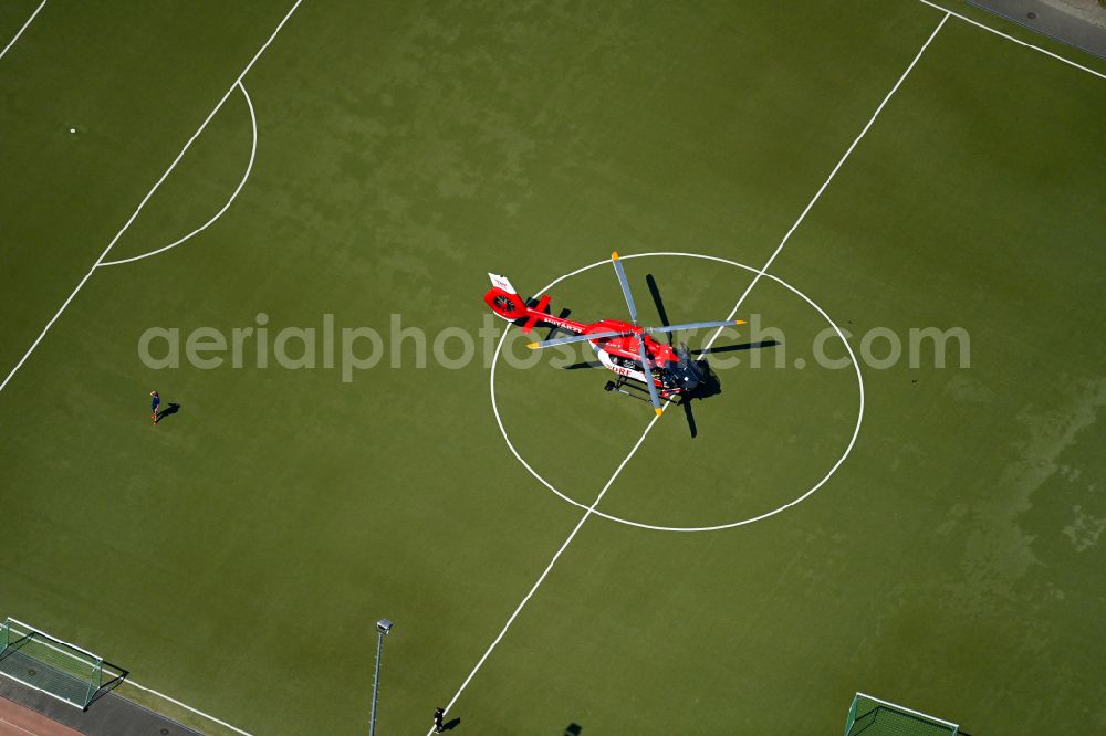 Aerial image Berlin - Sports grounds and football pitch with rescue helicopter employed for on emergency medical mission on street Gustav-Adolf-Strasse in Berlin, Germany