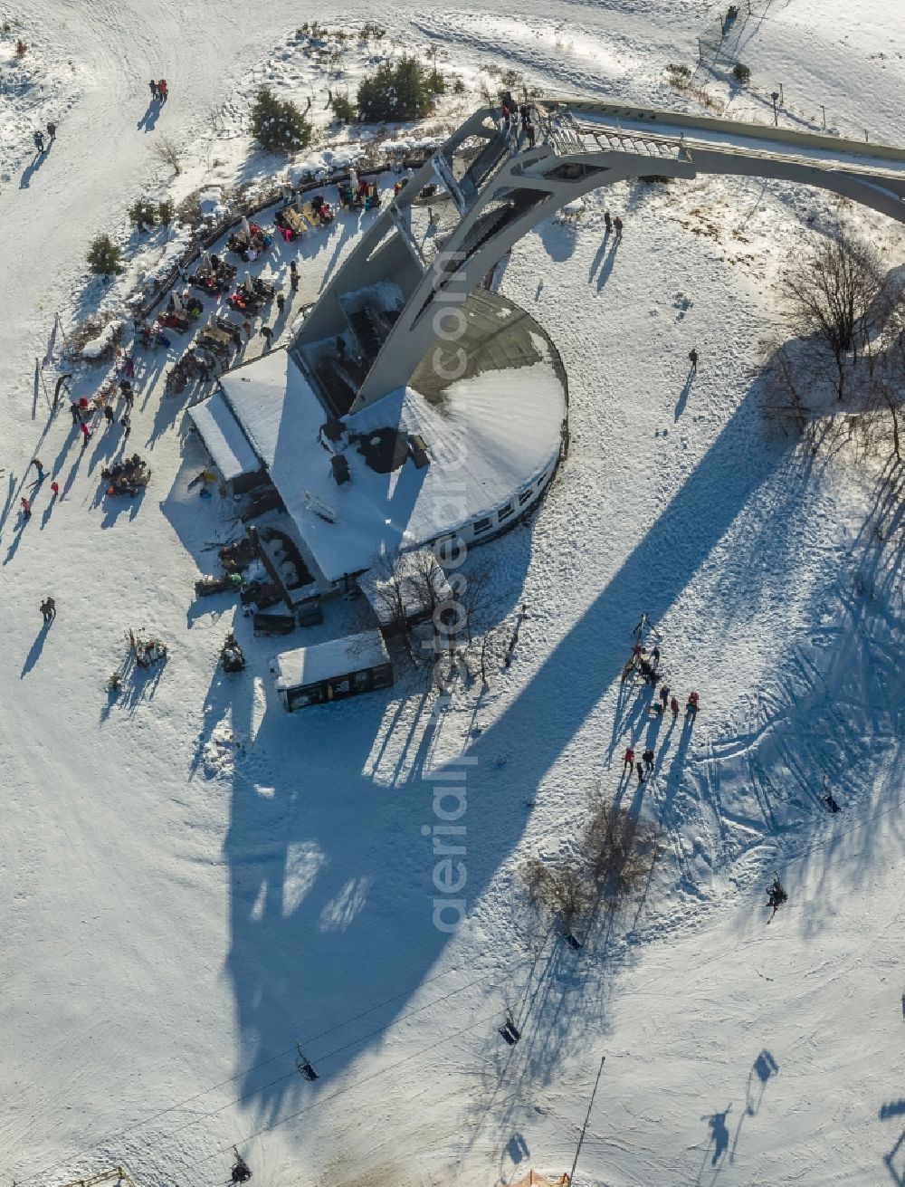 Aerial image Winterberg - View of the snow-covered foot of the St. Georg ski jump in Winterberg in the state North Rhine-Westphalia. Located in the tower base of the ski jump is the Restaurant Schanzentreff Restaurant 