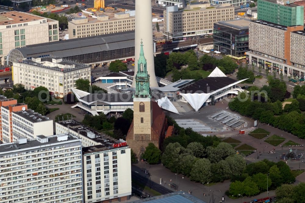 Berlin from the bird's eye view: The Protestant Church of St. Mary at the foot of the Berlin TV tower at Alexanderplatz in Berlin-Mitte. was built the Gothic brick church in the 13th century. In the background of the S- and U-railway station Alexanderplatz square and Rathauspassagen