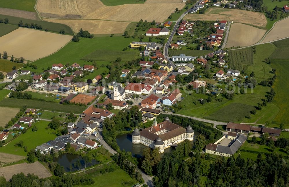 Aistersheim from above - View of the city Aistersheim and Aistersheim castle in the state Upper Austria in Austria. In the moated castle is the domicile of the estate management, it is located on the street Aistersheim, where the parish church of Aistersheim is located too, and is surrounded by a moat