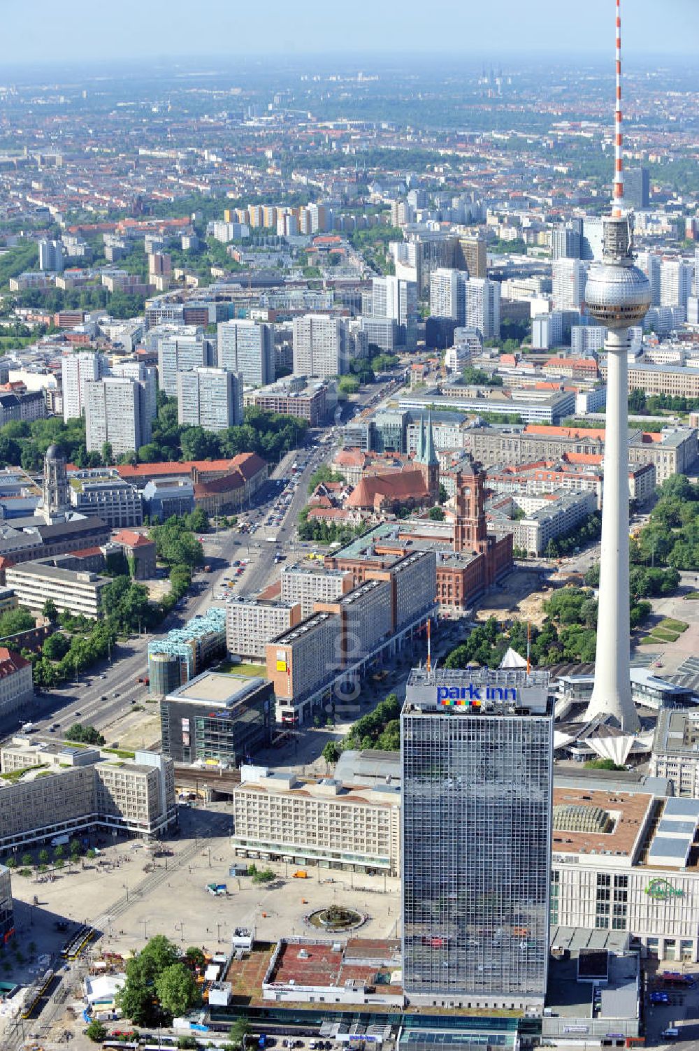 Aerial image Berlin Mitte - Stadtansicht Alexanderplatz mit Fernsehturm, Park Inn Hotel, Galeria Kaufhof Filiale, der Springbrunnen Brunnen der Völkerfreundschaft umgangssprachlich Nuttenbrosche, die Rathauspassagen, das Rote Rathaus mit Blickrichtung Nikolaiviertel. Townscape public square Alexanderplatz with the TV tower and other sights.