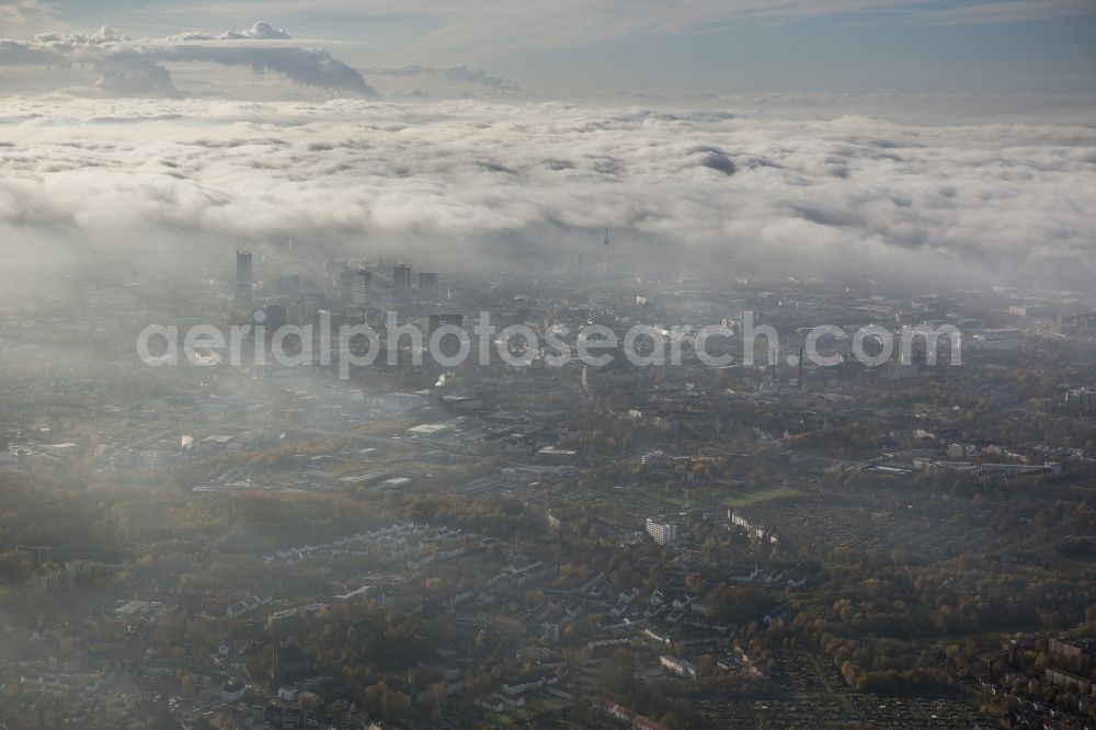 Essen from above - Stadtansicht über die von einer imposanten Nebel- und Wolken- Landschaft eingehüllte Skyline der Essener Innenstadt im Bundesland Nordrhein-Westfalen NRW. Die Herbt Wetter Wolken überziehen die Stadt im Ruhrgebiet mit einer weißen Wolkendecke und umschließen u.a. das Rathaus und den Sitz des Energieversorgers RWE im RWE- Turm am Opernplatz. / Cityscape overlooking the skyline of the Essen city center shrouded by an impressive landscape of fog and clouds in the state North Rhine-Westphalia. The autumn weather clouds cover the Ruhr region city with a thick blanket of clouds and surround among others the townhall and the RWE Tower at Opernplatz.