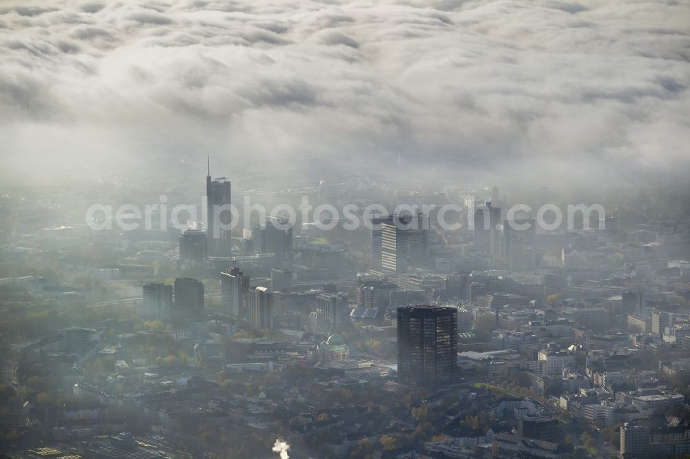 Aerial image Essen - Stadtansicht über die von einer imposanten Nebel- und Wolken- Landschaft eingehüllte Skyline der Essener Innenstadt im Bundesland Nordrhein-Westfalen NRW. Die Herbt Wetter Wolken überziehen die Stadt im Ruhrgebiet mit einer weißen Wolkendecke und umschließen u.a. das Rathaus und den Sitz des Energieversorgers RWE im RWE- Turm am Opernplatz. / Cityscape overlooking the skyline of the Essen city center shrouded by an impressive landscape of fog and clouds in the state North Rhine-Westphalia. The autumn weather clouds cover the Ruhr region city with a thick blanket of clouds and surround among others the townhall and the RWE Tower at Opernplatz.