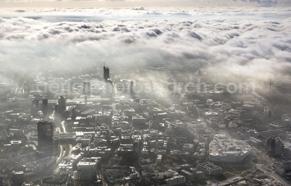 Aerial photograph Essen - Stadtansicht über die von einer imposanten Nebel- und Wolken- Landschaft eingehüllte Skyline der Essener Innenstadt im Bundesland Nordrhein-Westfalen NRW. Die Herbt Wetter Wolken überziehen die Stadt im Ruhrgebiet mit einer weißen Wolkendecke und umschließen u.a. das Rathaus und den Sitz des Energieversorgers RWE im RWE- Turm am Opernplatz. / Cityscape overlooking the skyline of the Essen city center shrouded by an impressive landscape of fog and clouds in the state North Rhine-Westphalia. The autumn weather clouds cover the Ruhr region city with a thick blanket of clouds and surround among others the townhall and the RWE Tower at Opernplatz.