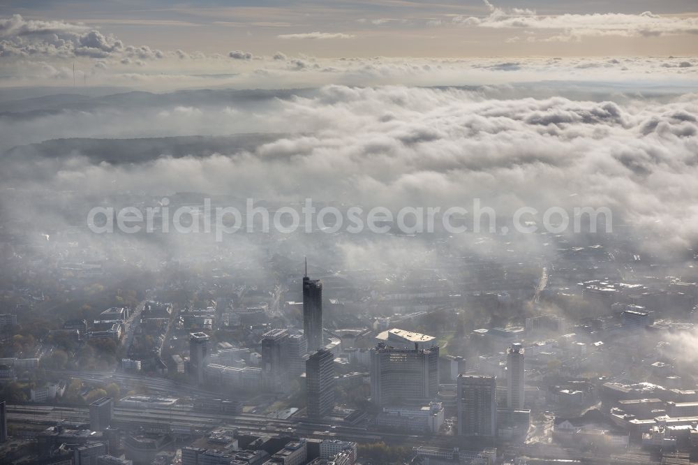 Aerial image Essen - Stadtansicht über die von einer imposanten Nebel- und Wolken- Landschaft eingehüllte Skyline der Essener Innenstadt im Bundesland Nordrhein-Westfalen NRW. Die Herbt Wetter Wolken überziehen die Stadt im Ruhrgebiet mit einer weißen Wolkendecke und umschließen u.a. das Rathaus und den Sitz des Energieversorgers RWE im RWE- Turm am Opernplatz. / Cityscape overlooking the skyline of the Essen city center shrouded by an impressive landscape of fog and clouds in the state North Rhine-Westphalia. The autumn weather clouds cover the Ruhr region city with a thick blanket of clouds and surround among others the townhall and the RWE Tower at Opernplatz.