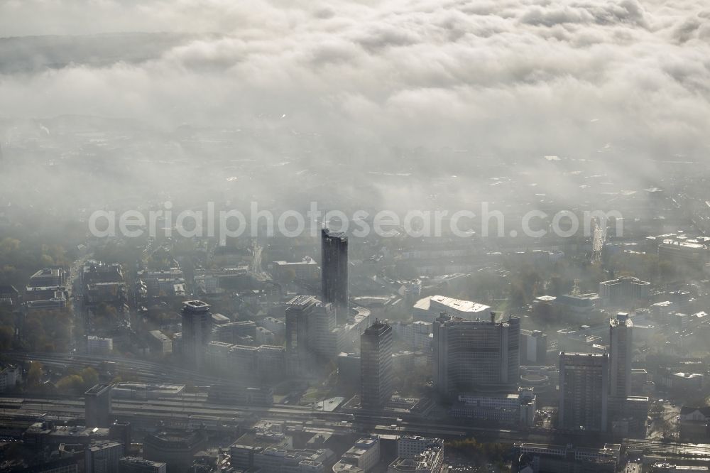 Aerial photograph Essen - Stadtansicht über die von einer imposanten Nebel- und Wolken- Landschaft eingehüllte Skyline der Essener Innenstadt im Bundesland Nordrhein-Westfalen NRW. Die Herbt Wetter Wolken überziehen die Stadt im Ruhrgebiet mit einer weißen Wolkendecke und umschließen u.a. das Rathaus und den Sitz des Energieversorgers RWE im RWE- Turm am Opernplatz. / Cityscape overlooking the skyline of the Essen city center shrouded by an impressive landscape of fog and clouds in the state North Rhine-Westphalia. The autumn weather clouds cover the Ruhr region city with a thick blanket of clouds and surround among others the townhall and the RWE Tower at Opernplatz.