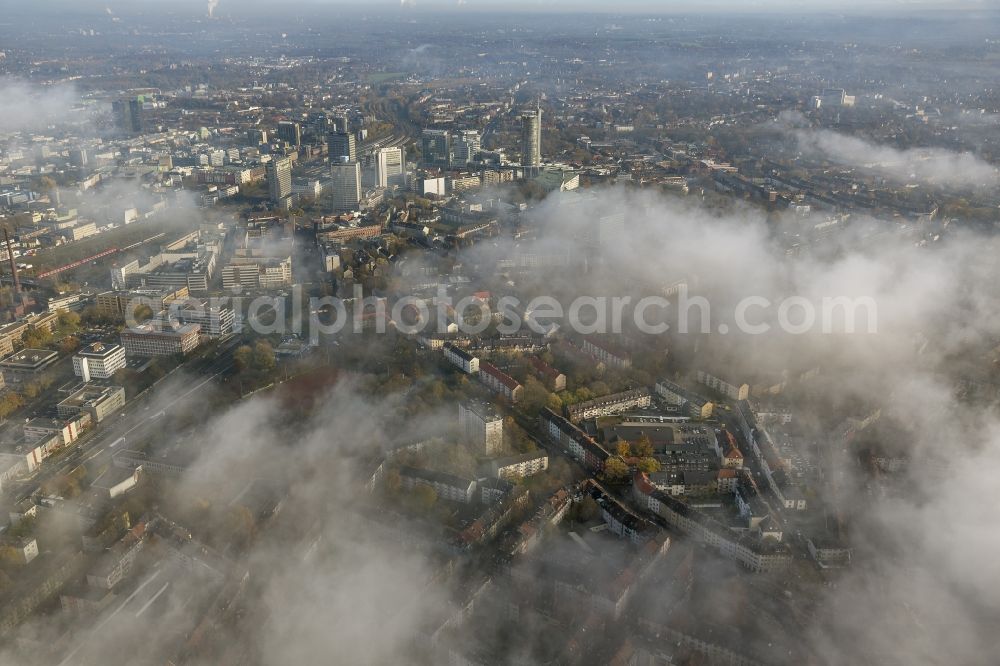 Aerial image Essen - Stadtansicht über die von einer imposanten Nebel- und Wolken- Landschaft eingehüllte Skyline der Essener Innenstadt im Bundesland Nordrhein-Westfalen NRW. Die Herbt Wetter Wolken überziehen die Stadt im Ruhrgebiet mit einer dichten Wolkendecke und umschließen u.a. das Rathaus und den Sitz des Energieversorgers RWE im RWE- Turm am Opernplatz. / Cityscape overlooking the skyline of the Essen city center shrouded by an impressive landscape of fog and clouds in the state North Rhine-Westphalia. The autumn weather clouds cover the Ruhr region city with a thick blanket of clouds and surround among others the townhall and the RWE Tower at Opernplatz.