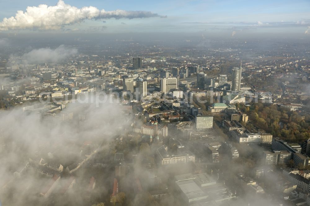 Aerial photograph Essen - Stadtansicht über die von einer imposanten Nebel- und Wolken- Landschaft eingehüllte Skyline der Essener Innenstadt im Bundesland Nordrhein-Westfalen NRW. Die Herbt Wetter Wolken überziehen die Stadt im Ruhrgebiet mit einer dichten Wolkendecke und umschließen u.a. das Rathaus und den Sitz des Energieversorgers RWE im RWE- Turm am Opernplatz. / Cityscape overlooking the skyline of the Essen city center shrouded by an impressive landscape of fog and clouds in the state North Rhine-Westphalia. The autumn weather clouds cover the Ruhr region city with a thick blanket of clouds and surround among others the townhall and the RWE Tower at Opernplatz.