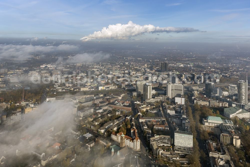 Essen from above - Stadtansicht über die von einer imposanten Nebel- und Wolken- Landschaft eingehüllte Skyline der Essener Innenstadt im Bundesland Nordrhein-Westfalen NRW. Die Herbt Wetter Wolken überziehen die Stadt im Ruhrgebiet mit einer dichten Wolkendecke und umschließen u.a. das Rathaus und den Sitz des Energieversorgers RWE im RWE- Turm am Opernplatz. / Cityscape overlooking the skyline of the Essen city center shrouded by an impressive landscape of fog and clouds in the state North Rhine-Westphalia. The autumn weather clouds cover the Ruhr region city with a thick blanket of clouds and surround among others the townhall and the RWE Tower at Opernplatz.