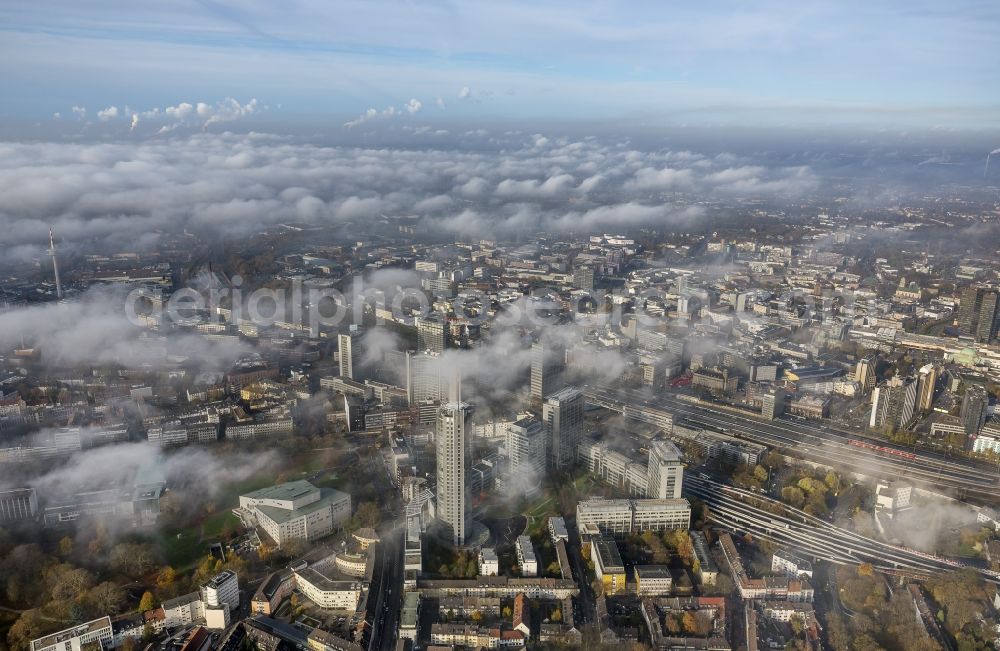 Aerial image Essen - Stadtansicht über die von einer imposanten Nebel- und Wolken- Landschaft eingehüllte Skyline der Essener Innenstadt im Bundesland Nordrhein-Westfalen NRW. Die Herbt Wetter Wolken überziehen die Stadt im Ruhrgebiet mit einer dichten Wolkendecke und umschließen u.a. das Rathaus und den Sitz des Energieversorgers RWE im RWE- Turm am Opernplatz. / Cityscape overlooking the skyline of the Essen city center shrouded by an impressive landscape of fog and clouds in the state North Rhine-Westphalia. The autumn weather clouds cover the Ruhr region city with a thick blanket of clouds and surround among others the townhall and the RWE Tower at Opernplatz.