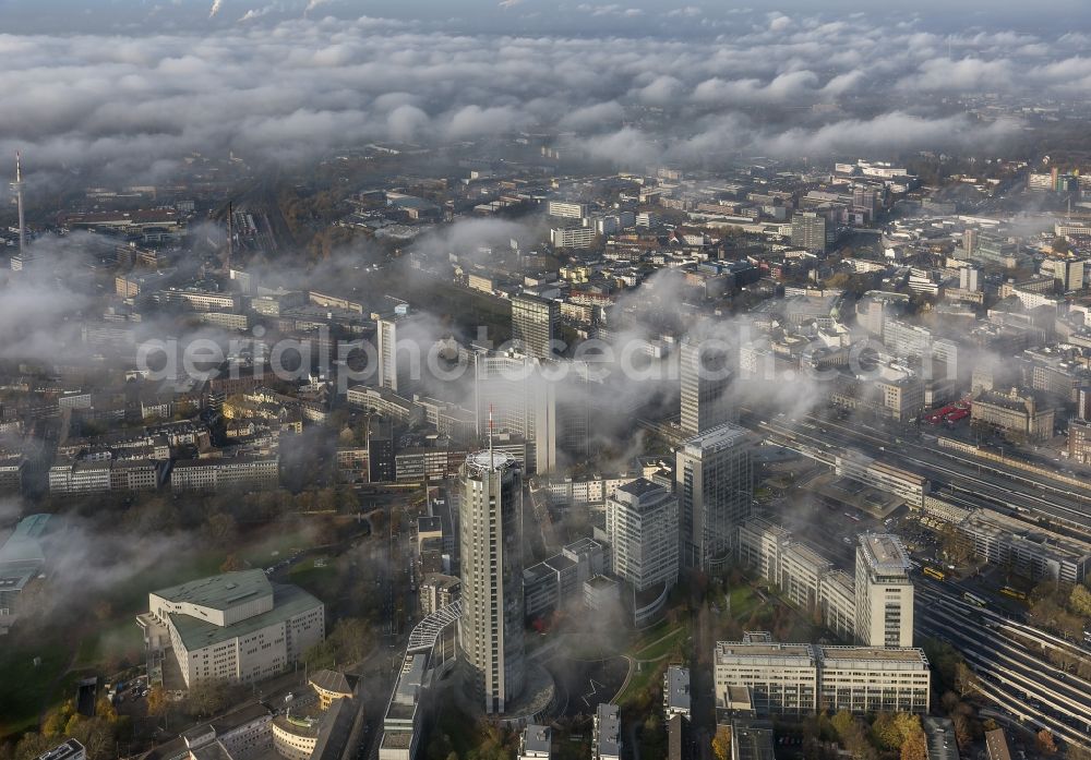 Aerial photograph Essen - Stadtansicht über die von einer imposanten Nebel- und Wolken- Landschaft eingehüllte Skyline der Essener Innenstadt im Bundesland Nordrhein-Westfalen NRW. Die Herbt Wetter Wolken überziehen die Stadt im Ruhrgebiet mit einer dichten Wolkendecke und umschließen u.a. das Rathaus und den Sitz des Energieversorgers RWE im RWE- Turm am Opernplatz. / Cityscape overlooking the skyline of the Essen city center shrouded by an impressive landscape of fog and clouds in the state North Rhine-Westphalia. The autumn weather clouds cover the Ruhr region city with a thick blanket of clouds and surround among others the townhall and the RWE Tower at Opernplatz.