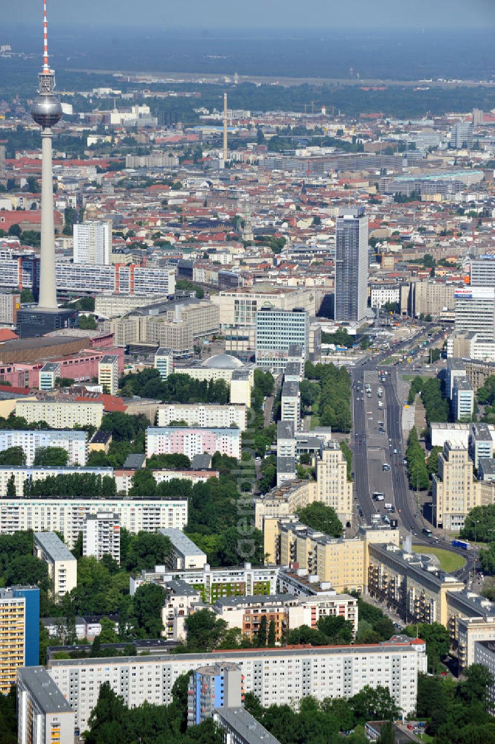 Berlin Mitte from the bird's eye view: Stadtansicht entlang der Karl-Marx-Allee mit dem Strausberger Platz in Richtung Berlin-Mitte mit Fernsehturm am Alexanderplatz. Townscape along the street Karl-Marx-Allee with the square Strausbergerplatz in the direction to the TV tower at the public square Alexanderplatz.