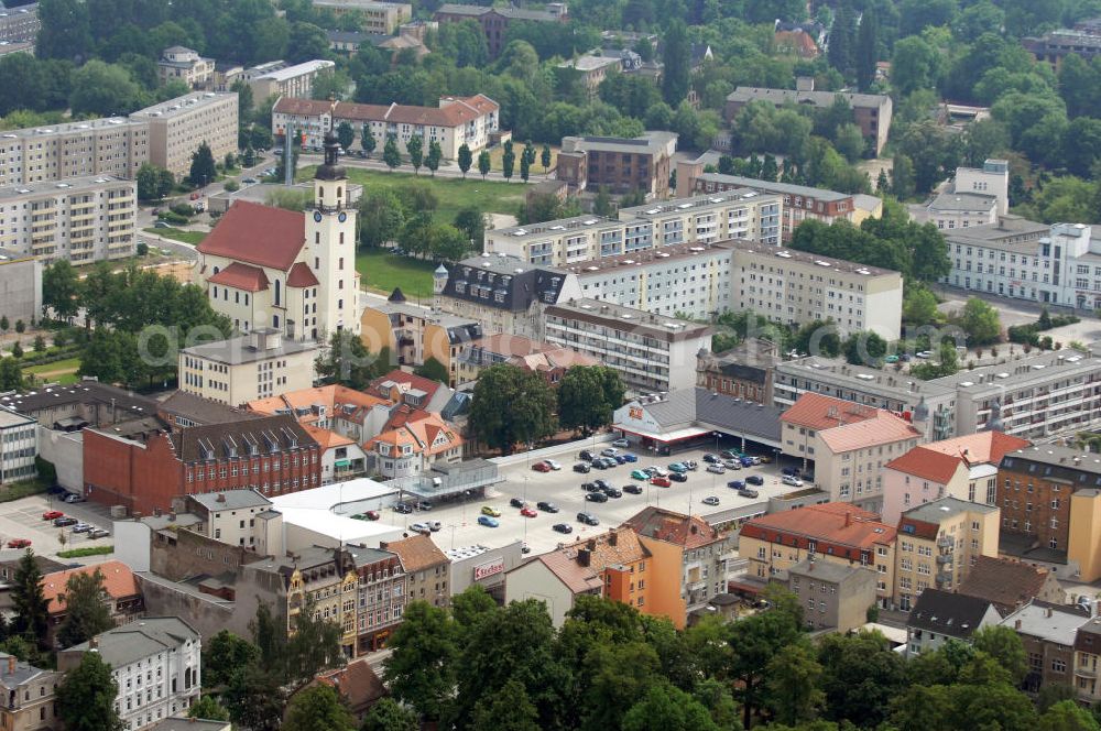 Aerial photograph Forst / Lausitz - View over a supermarket with parking level onto the parish church of St. Nicholas Forst in Lusatia