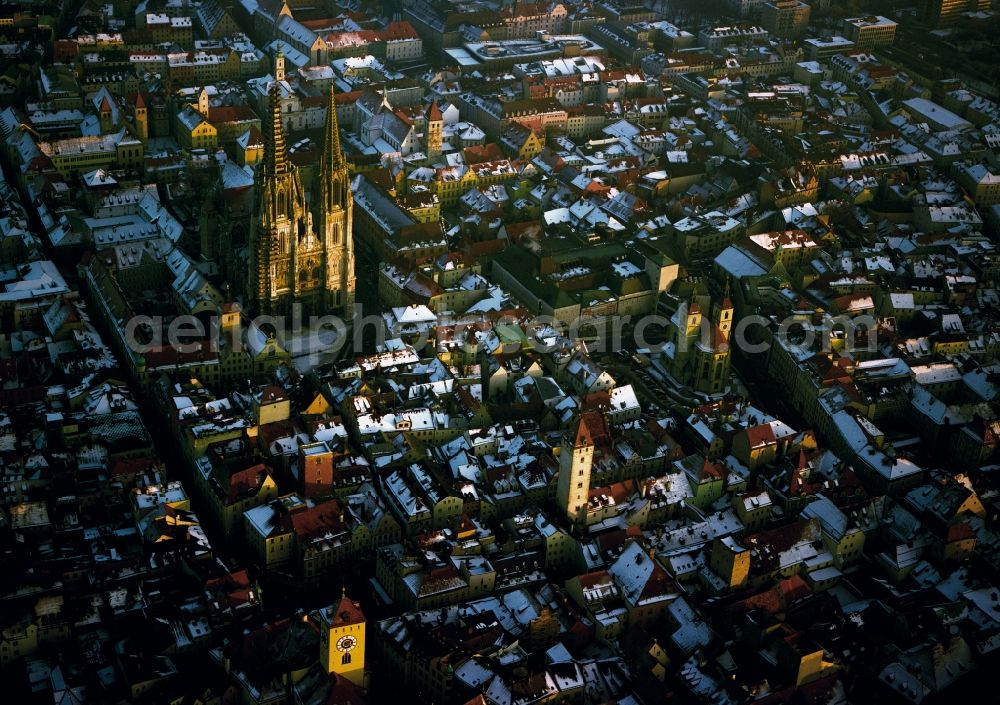 Aerial image Regensburg - Panoramic view of downtown Regensburg in the state of Bavaria. The city is crossed by the river Danube in West-East direction. The river includes two islands at the historic city centre. The St. Peter cathedral (Regensburger Dom) with its twin towers - built in gothic style - is seen from the west in sunset